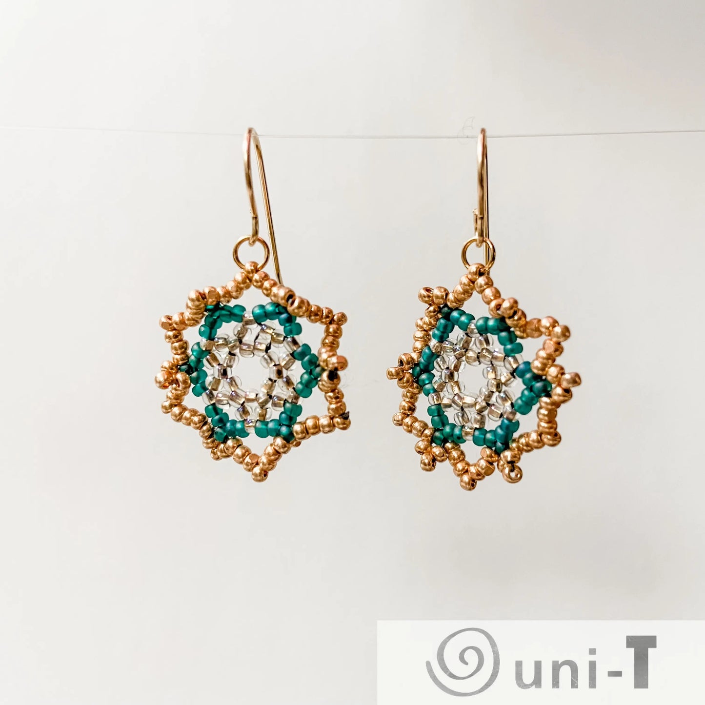Sterling Silver Green Medallion Earrings featuring intricate floral beadwork in forest tones, perfect for elegant and artistic styling.