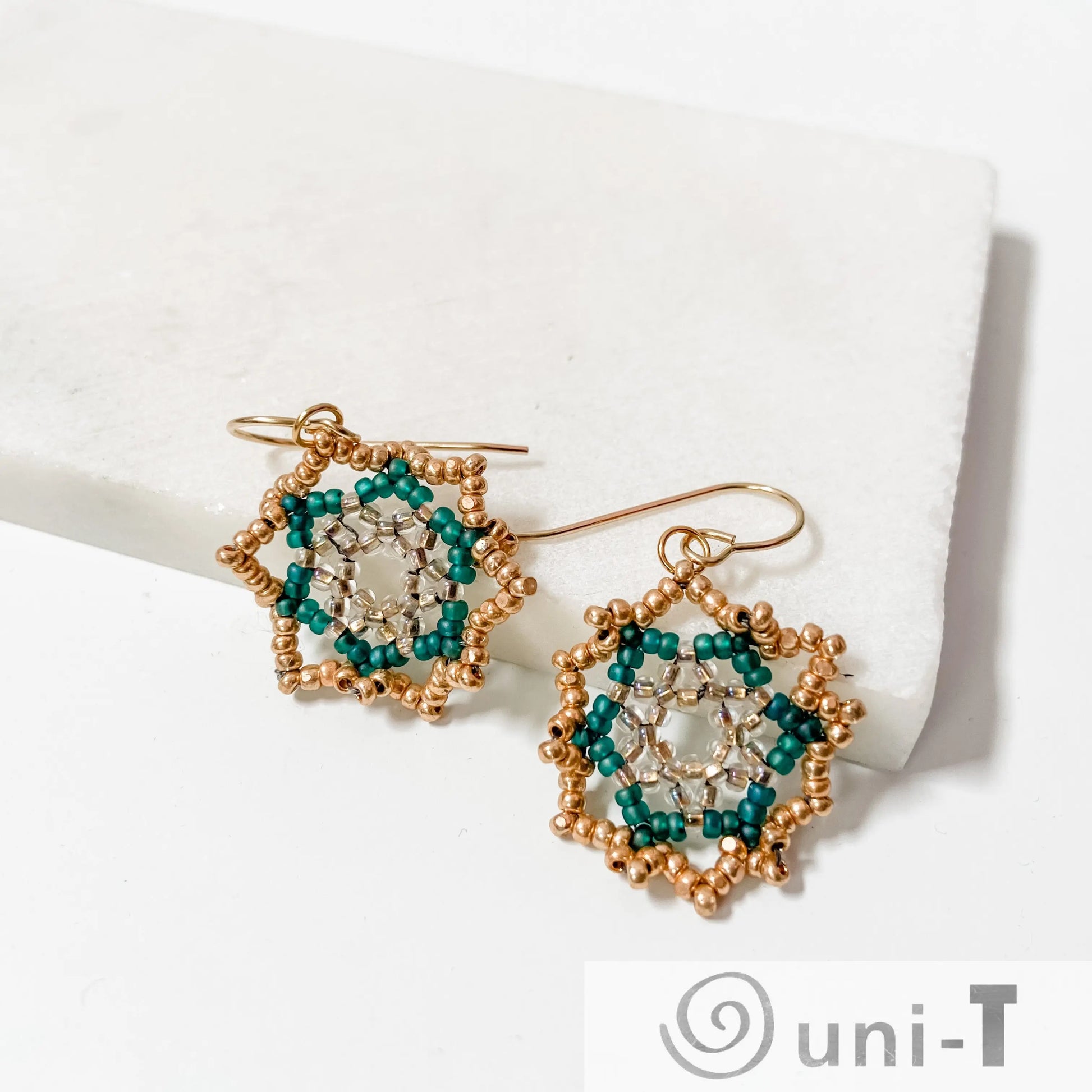 Handcrafted Green Medallion Earrings with luminous green and gold beads in a floral design, suspended from sterling silver ear wires.