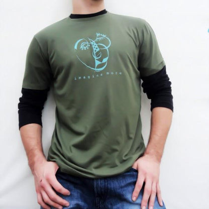 Olive green men's art t-shirt layered over black sleeves, featuring blue 'Imagine More' abstract print. Urban eco-style for creatives.