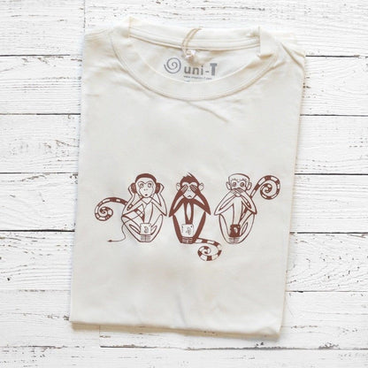 Men's Three Wise Monkeys T-Shirt in bamboo & organic cotton, folded on white wood background with brown monkey graphic print.