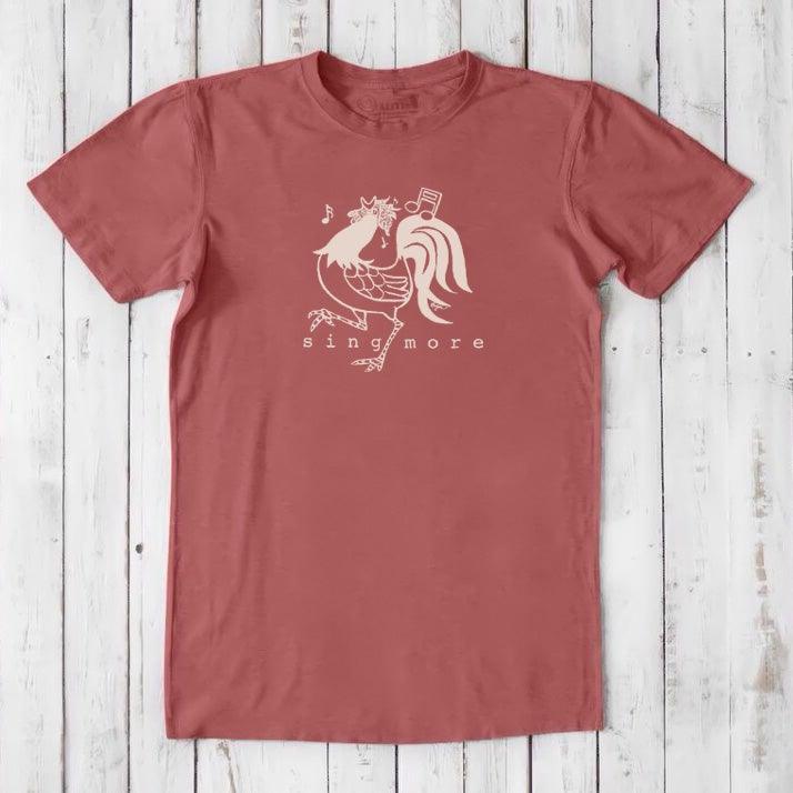 Rust red men's 'Sing More' rooster t-shirt in bamboo and organic cotton, featuring a light-colored humorous farm animal print.