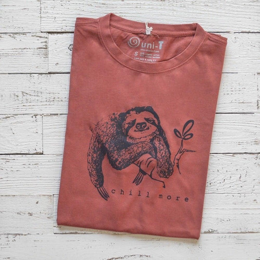 Folded rust red men's sloth T-shirt in bamboo and organic cotton with 'Chill More' graphic, relaxed fit eco-friendly tee for him.