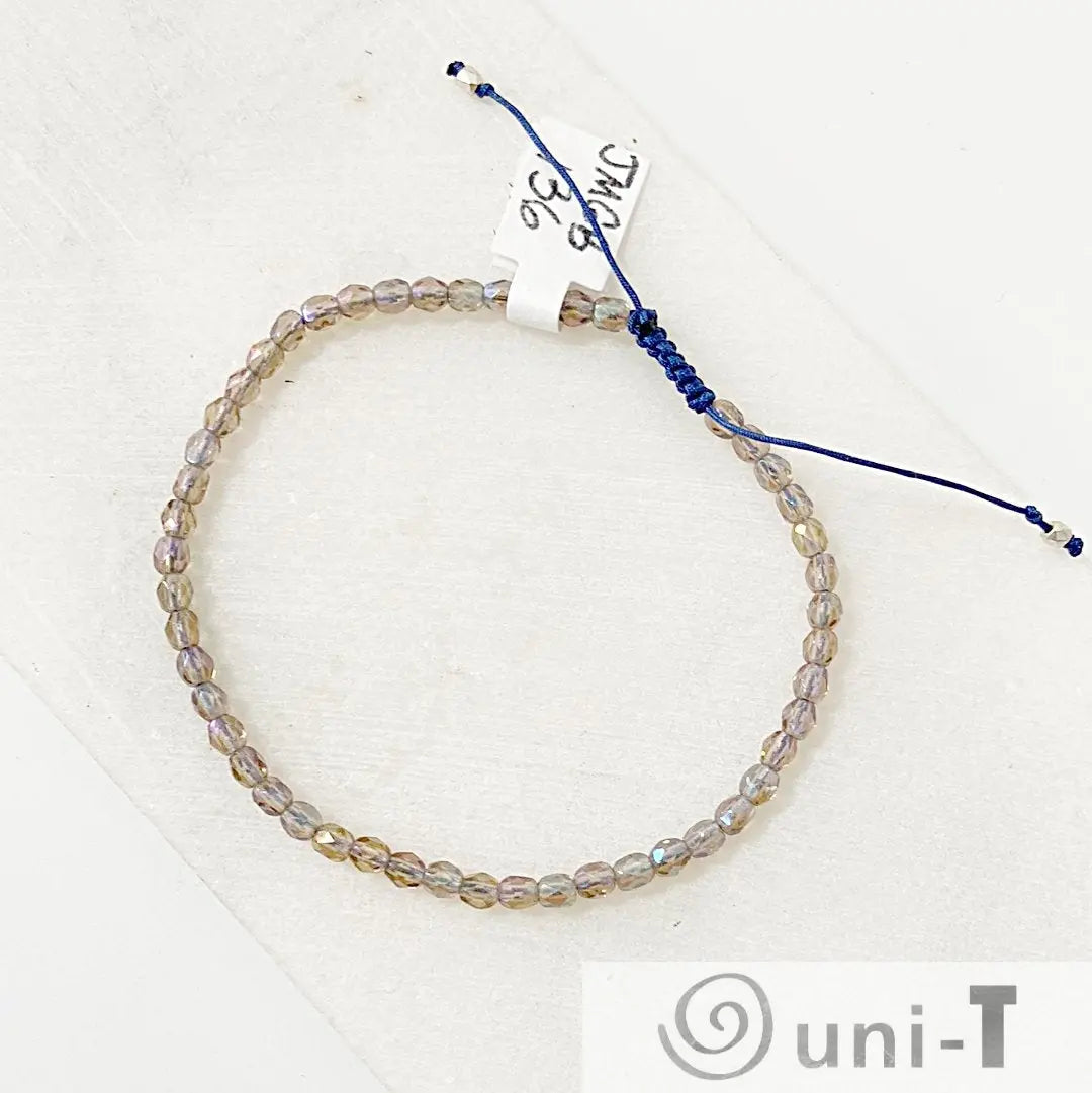 Adjustable friendship bracelet with micro glass beads and navy cord, stackable and secure for everyday wear or gifting.