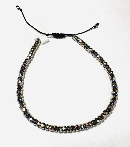 Duplicate image of metallic glass bead adjustable bracelet with black cord. Stackable design for gifting or personal accessory collection.