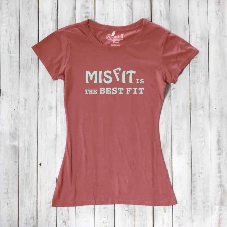 Rust red women's t-shirt featuring 'Misfit is the Best Fit' slogan. Made from soft bamboo and organic cotton for eco-conscious wear.
