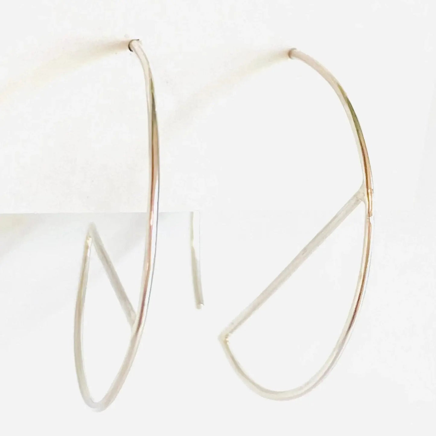 Minimalist sterling silver hoop earrings with geometric bar design. Modern 1” diameter hoops perfect for stylish everyday accessories.