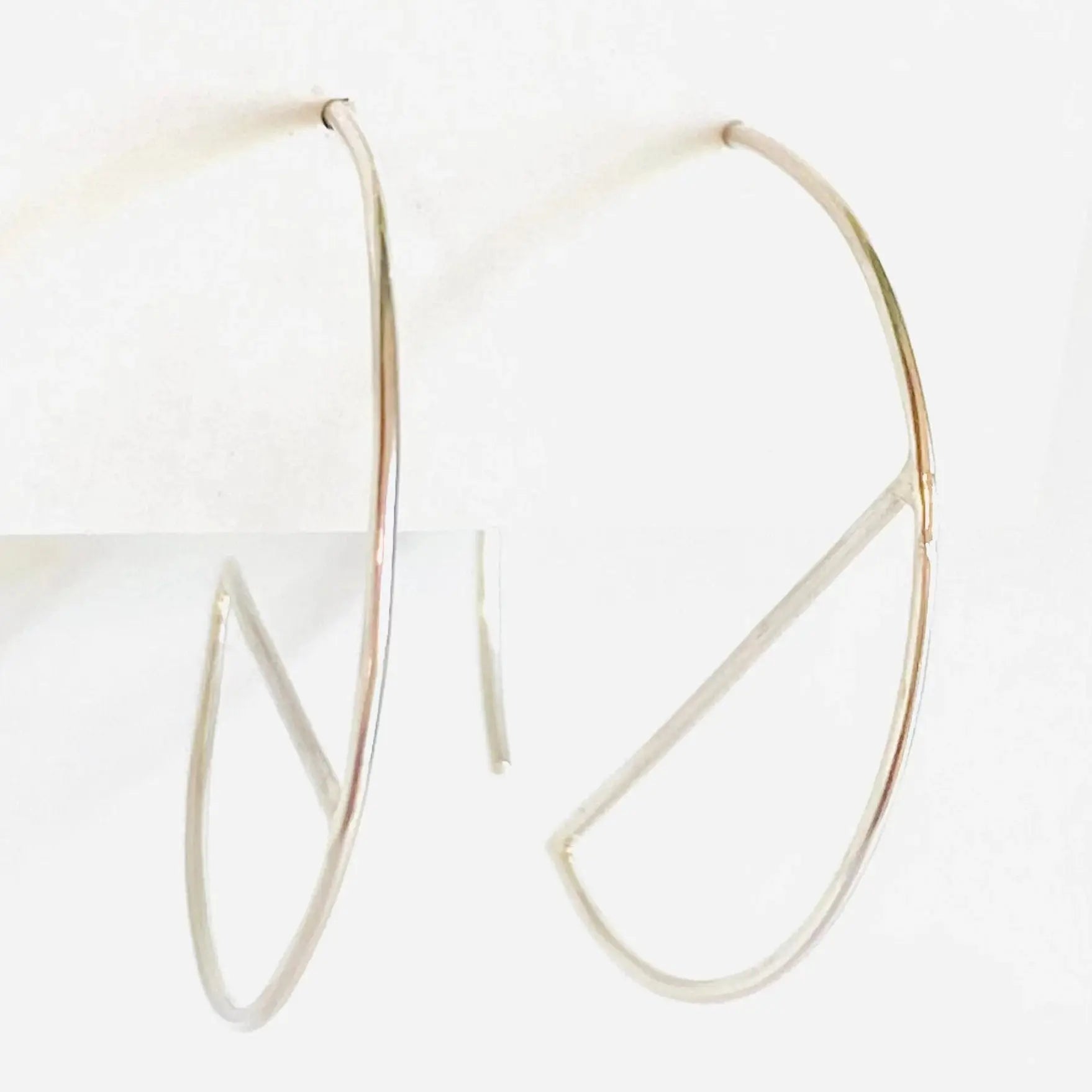 Minimalist sterling silver hoop earrings with geometric bar design. Modern 1” diameter hoops perfect for stylish everyday accessories.