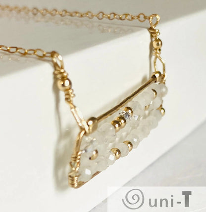 Side angle of Moonstone Bar Necklace highlighting the intricate wire-wrapped gold-filled bar and translucent moonstone beads. Elegant handmade jewelry.