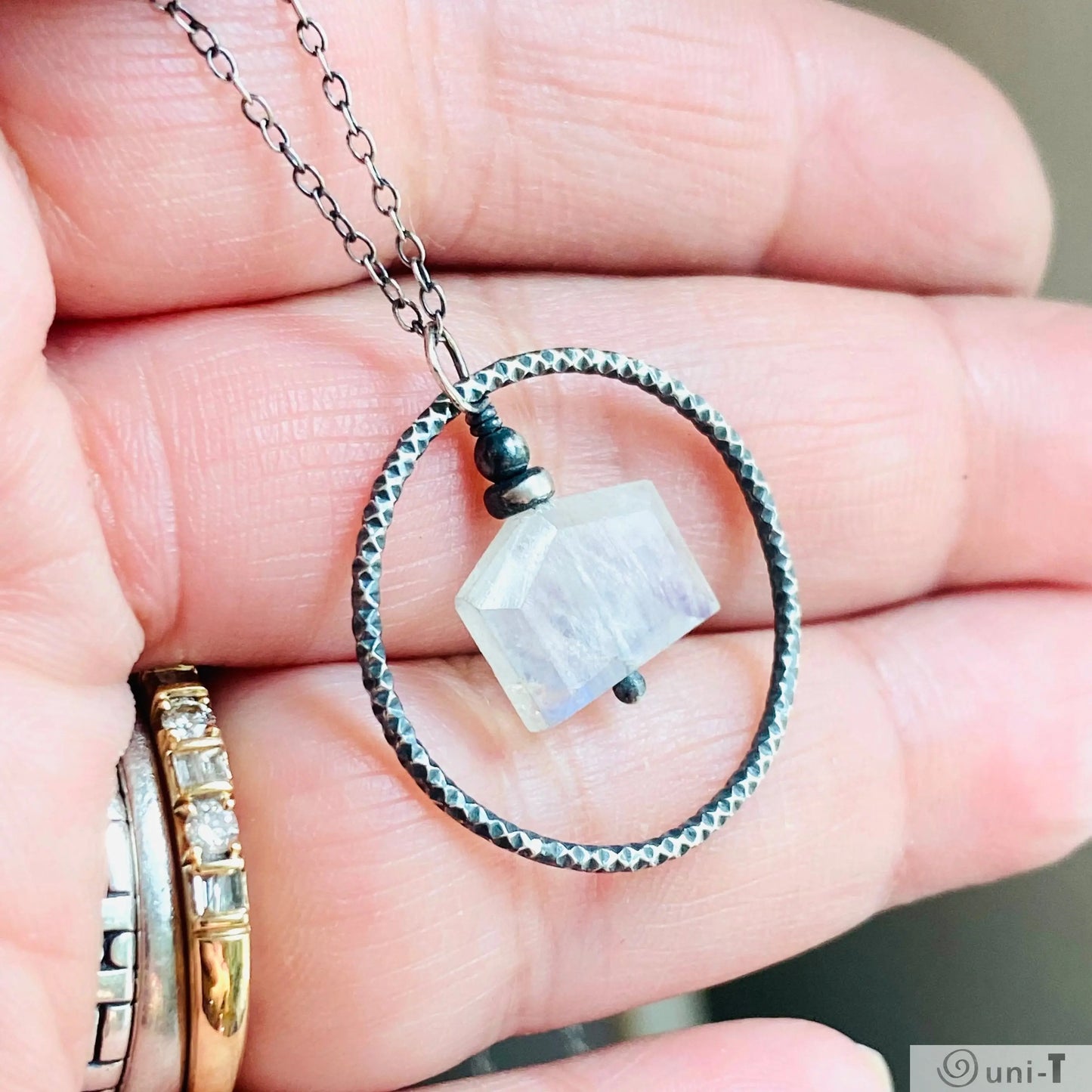 Close-up of Moonstone Infinity Necklace featuring hand-soldered silver circle and moonstone charm, ideal for fashion accessories.