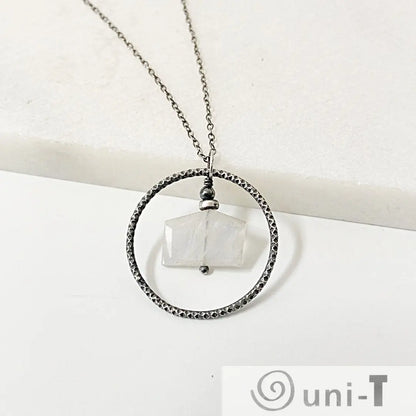 Sterling Silver Moonstone Necklace with geometric moonstone wrapped in center of textured circle, elegant infinity jewelry piece.
