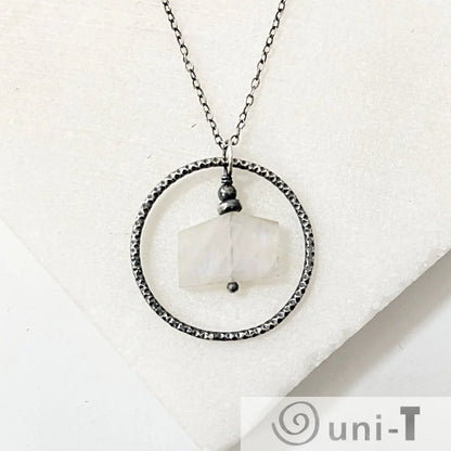 Infinity Necklace with moonstone pendant in hammered silver circle, handcrafted for a unique jewelry accessory look.