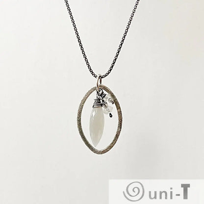 Moonstone Dagger Necklace with sterling silver oval frame and moonstone bead pendant. Modern minimalist jewelry from Moonstone Necklace Set.