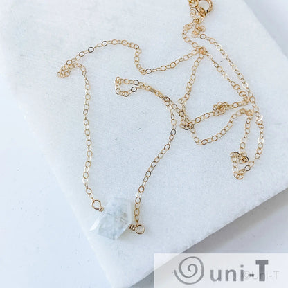Gold-filled moonstone necklace with raw-cut gemstone pendant, perfect for accessorizing with meaning and minimalist style.