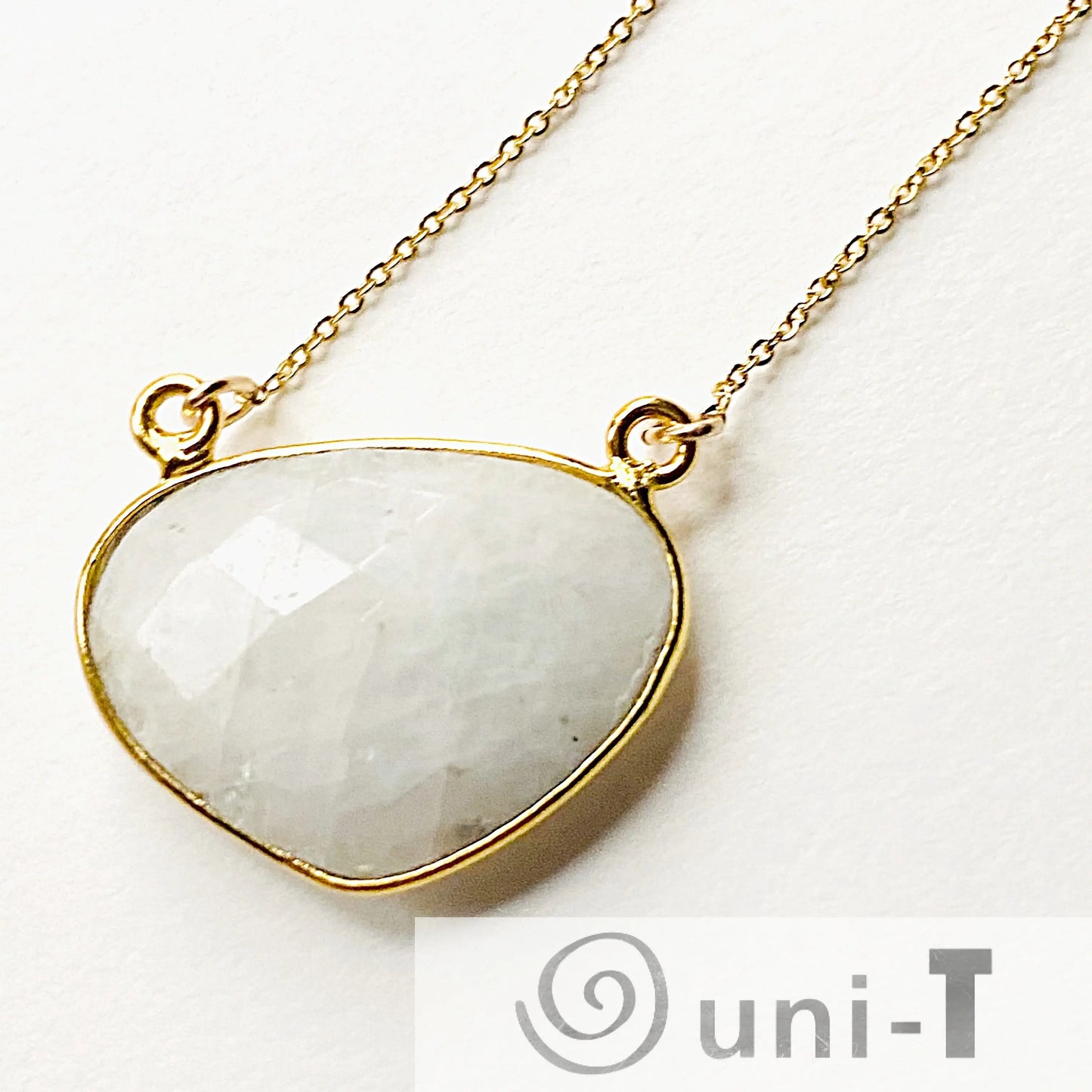 Close-up of moonstone necklace with faceted gemstone set in gold filled bezel. A minimalist and stylish accessory for any outfit.