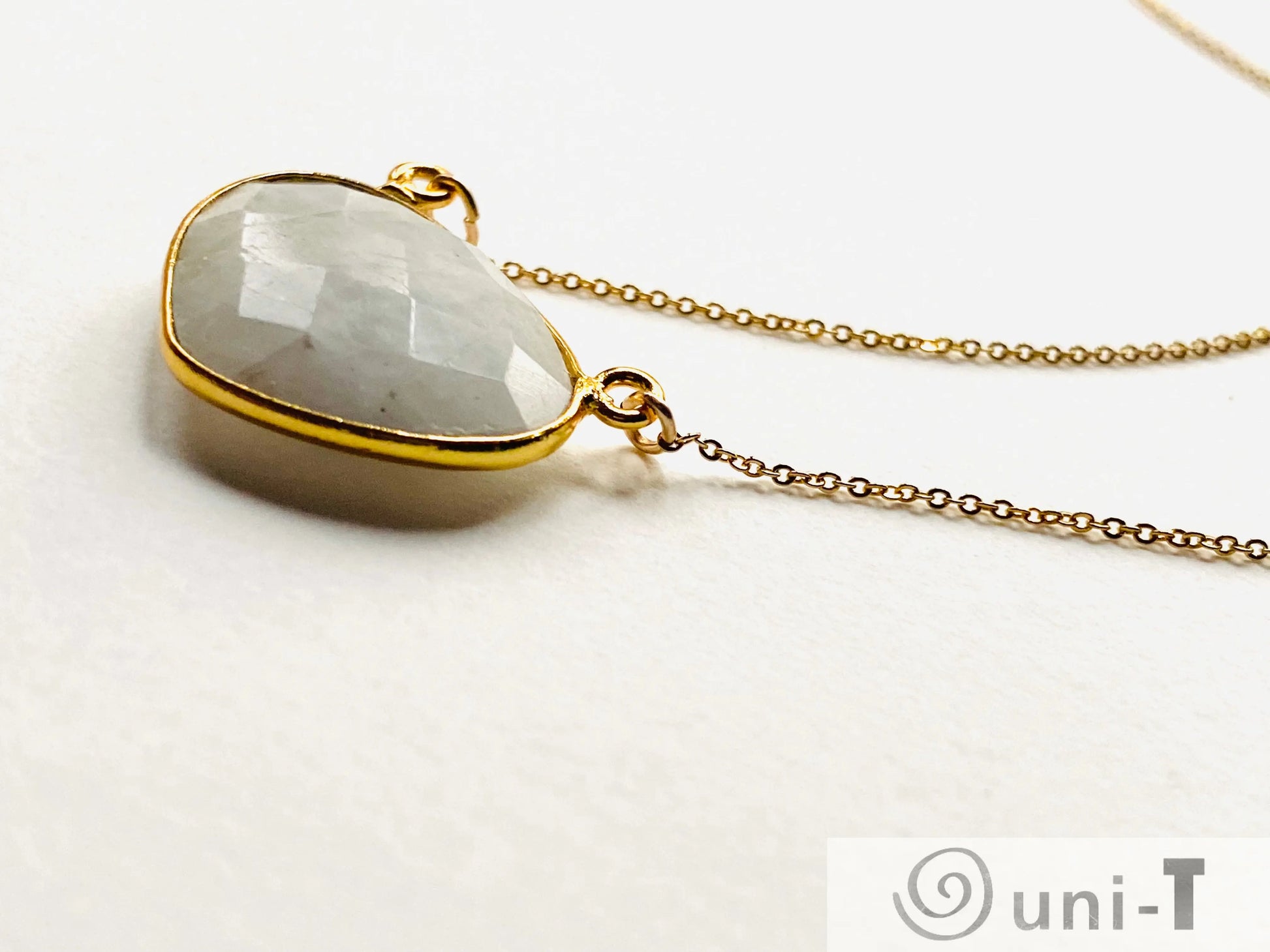 Side view of moonstone gemstone pendant on gold filled necklace. Highlights the thickness and quality of the bezel setting.