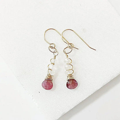 Gemstone earrings featuring hand-cut moonstone and pink tourmaline with gold-filled wire, 1.5 inches long. Elegant drop design for all occasions.