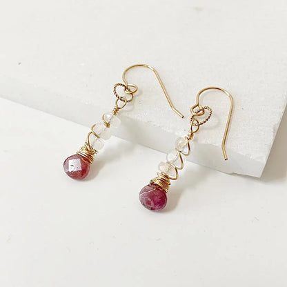 Moonstone and tourmaline gemstone earrings with gold-filled accents. Dangle style, 1.5-inch length, perfect for stylish accessory lovers.