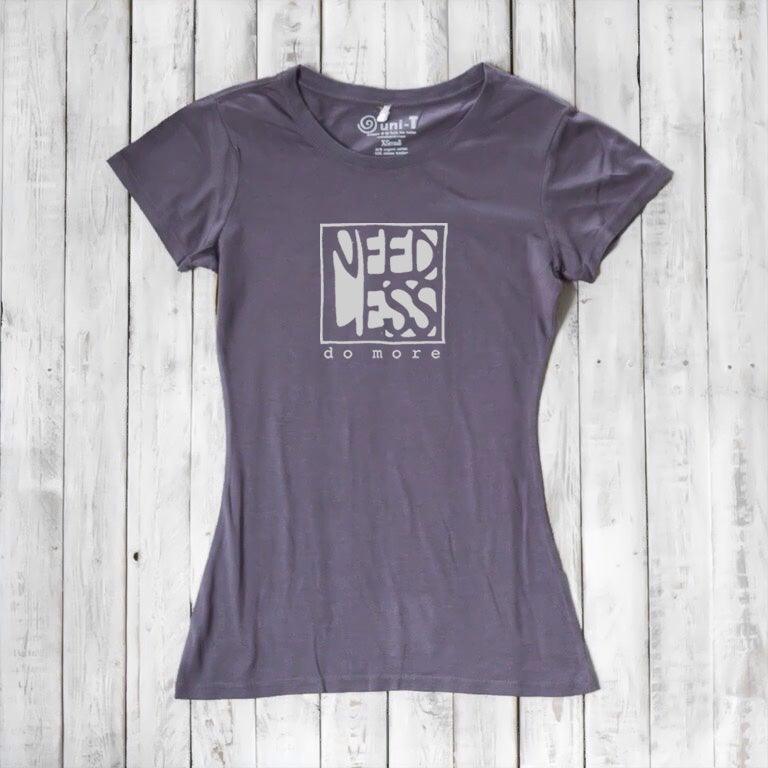 Charcoal grey women's organic cotton and bamboo tee with 'Need Less Do More' quote. Eco-friendly minimalist fashion top.