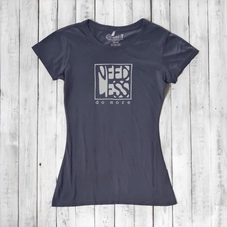 Navy blue women's inspirational t-shirt in bamboo and organic cotton. Features 'Need Less Do More' quote for minimalist lifestyle lovers.