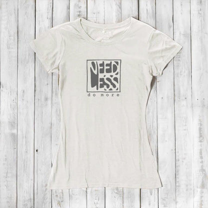 Ivory white women's bamboo and organic cotton t-shirt with 'Need Less Do More' quote. Minimalist and eco-conscious fashion top.