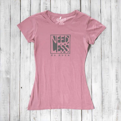 Soft pink women's motivational t-shirt in bamboo and organic cotton. 'Need Less Do More' quote tee for sustainable minimalist style.