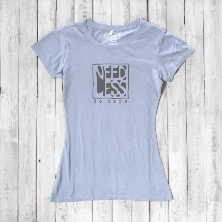 Light lavender women's bamboo and organic cotton t-shirt with 'Need Less Do More' quote. Sustainable minimalist fashion gift.
