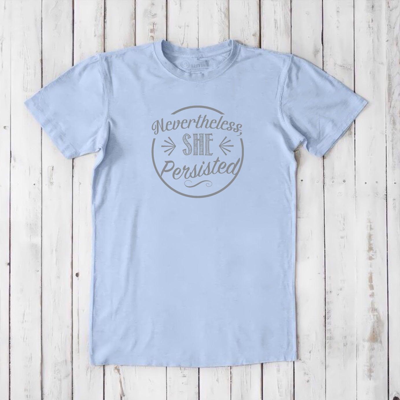 Men's 'She Persisted' T-Shirt in pale blue bamboo cotton, subtle feminist graphic tee for sustainable wardrobes.