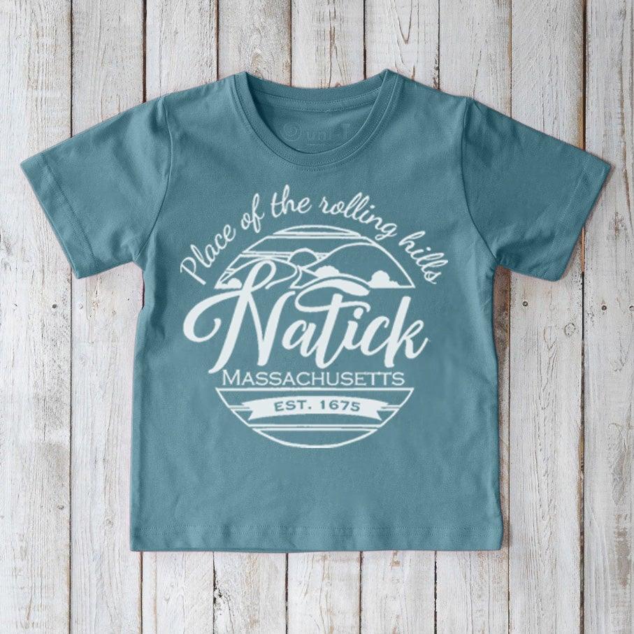 Kids' Natick Organic Cotton T-Shirt in blue with 'Place of the rolling hills' graphic. Eco-friendly local pride tee by Uni-T for children.