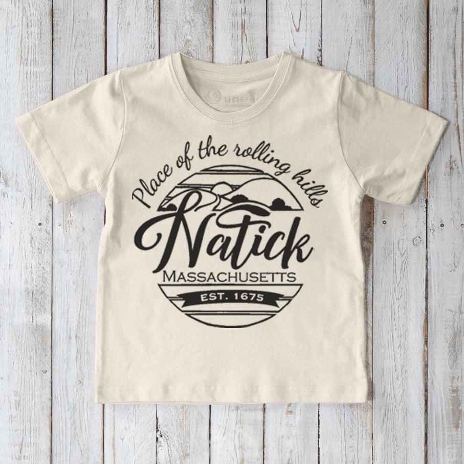 Beige Kids' Natick Organic Cotton T-Shirt with bold black town pride graphic. Sustainable children's tee by Uni-T.