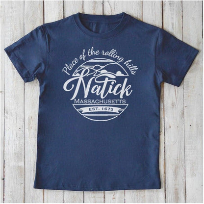 Navy blue Kids' Natick Organic Cotton T-Shirt with white Massachusetts town pride graphic. Sustainable Uni-T tee for children.