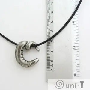 Nematode C elegans Necklace - Scientific Jewelry shown with ruler for scale, highlighting the pendant's compact size and scientific design appeal.