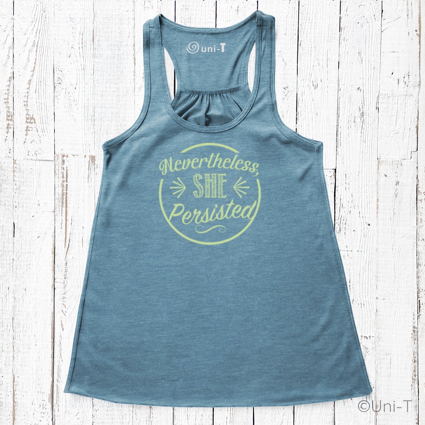 Blue racerback tank top featuring yellow 'Nevertheless She Persisted' graphic. Soft poly-viscose blend for resilient women's fashion.