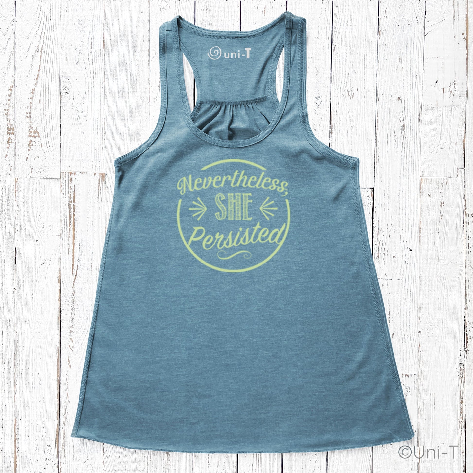 Blue racerback tank top featuring yellow 'Nevertheless She Persisted' graphic. Soft poly-viscose blend for resilient women's fashion.