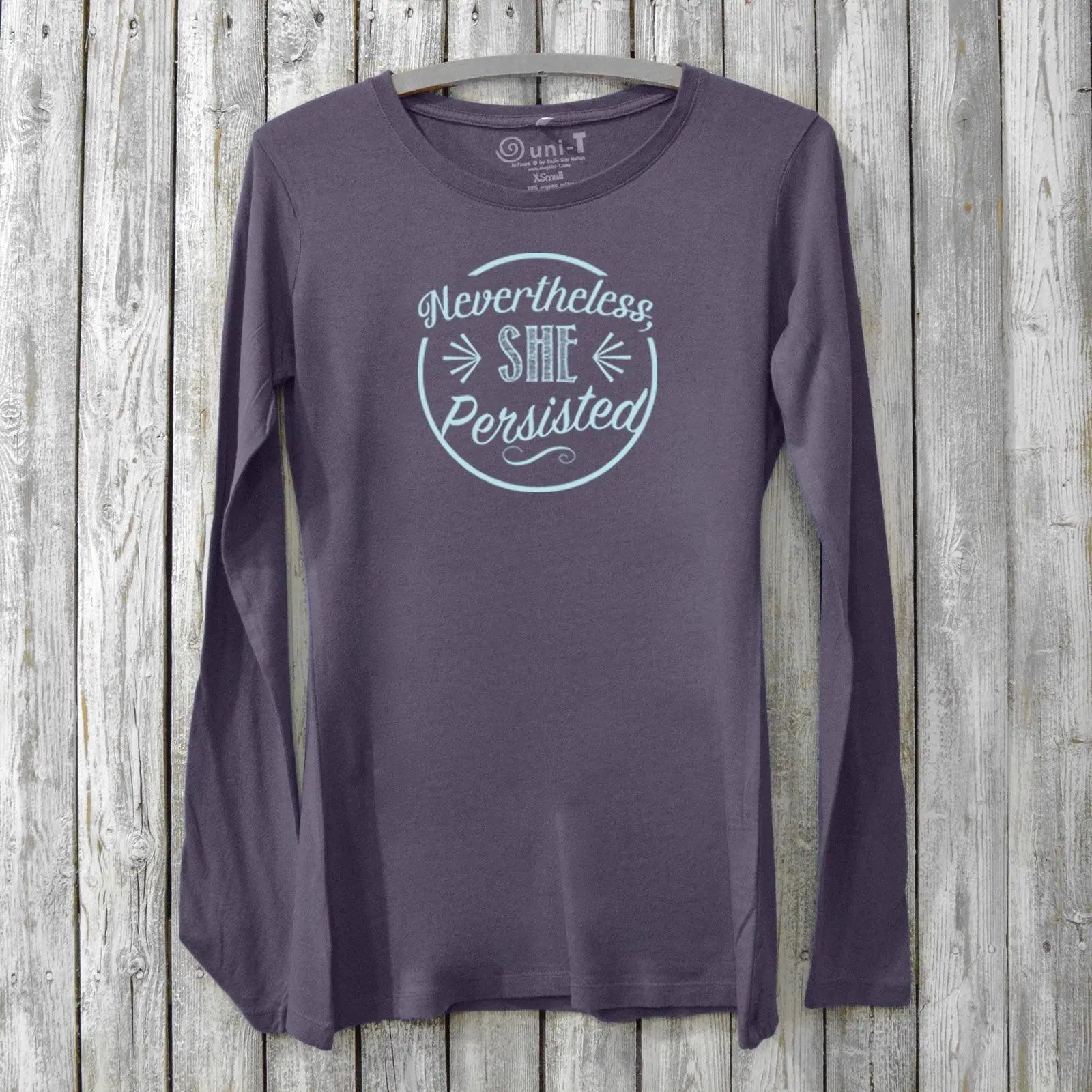 Women's empowerment long sleeve T-shirt in dark purple bamboo and organic cotton with 'Nevertheless She Persisted' graphic. Feminist activist apparel.