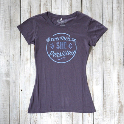 Women's 'Nevertheless She Persisted' tee in dark gray with blue text, made from bamboo and organic cotton. Feminist empowerment top by Uni-T.