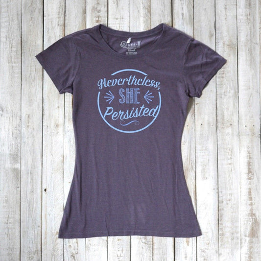 Women's 'Nevertheless She Persisted' tee in dark gray with blue text, made from bamboo and organic cotton. Feminist empowerment top by Uni-T.