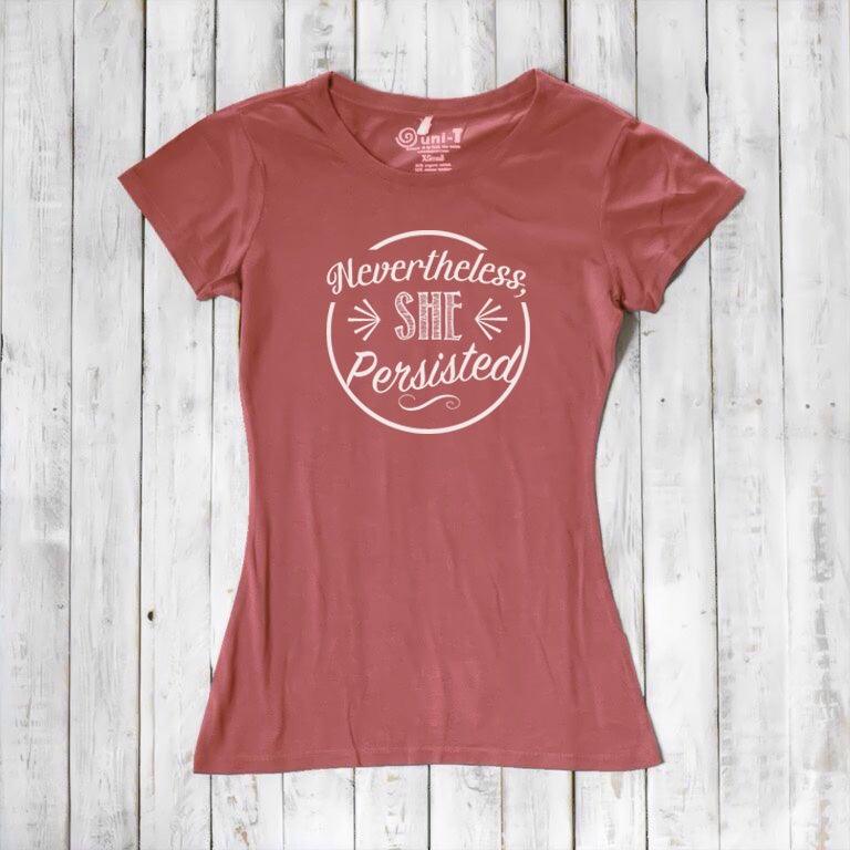 Rust red 'Nevertheless She Persisted' women's t-shirt with white text. Sustainable bamboo and organic cotton feminist gift by Uni-T.