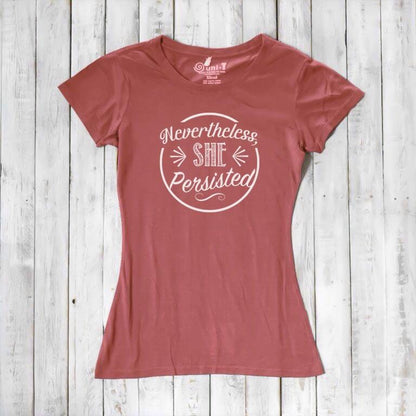 Rust red 'Nevertheless She Persisted' women's t-shirt with white text. Sustainable bamboo and organic cotton feminist gift by Uni-T.