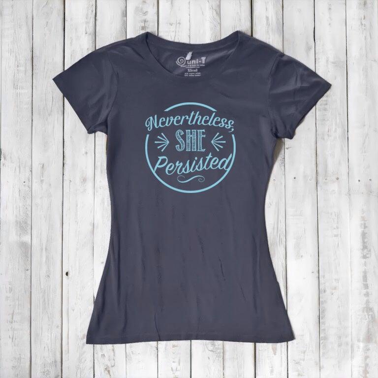 Charcoal gray 'Nevertheless She Persisted' women's tee with blue text. Feminist empowerment shirt made from sustainable bamboo and cotton.