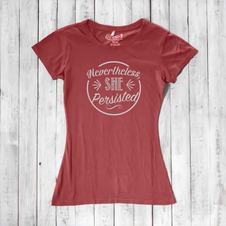 Coral red 'Nevertheless She Persisted' women's tee with white text. Eco-friendly bamboo and organic cotton feminist shirt by Uni-T.