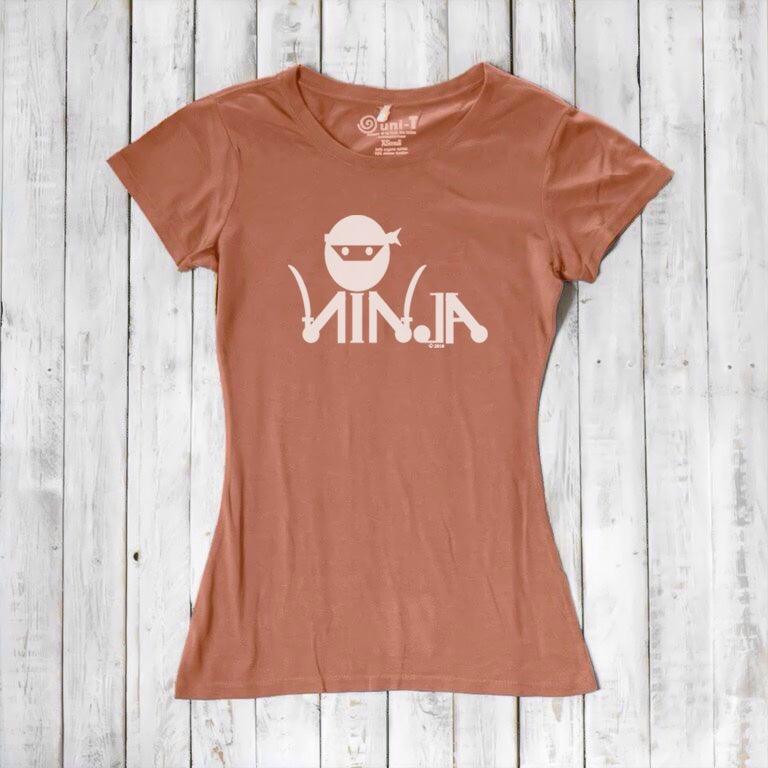 Rust orange Women's Ninja T-Shirt with white ninja graphic, crafted from bamboo & organic cotton for eco-friendly martial arts fashion.