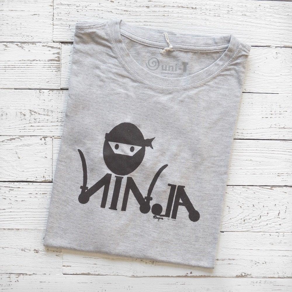 Men's Ninja T-Shirt in Bamboo & Organic Cotton folded on white wood, featuring black 'Stealth Mode' ninja graphic in classic fit.