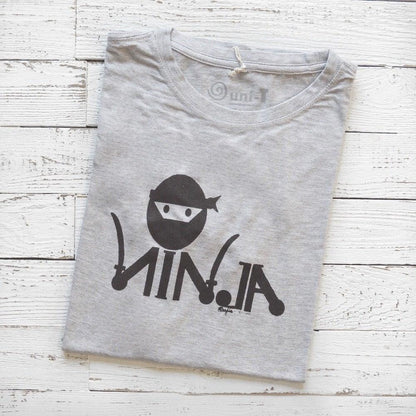 Men's Ninja T-Shirt in Bamboo & Organic Cotton folded on white wood, featuring black 'Stealth Mode' ninja graphic in classic fit.