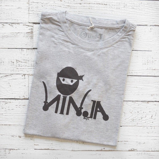 Men's Ninja T-Shirt in Bamboo & Organic Cotton folded on white wood, featuring black 'Stealth Mode' ninja graphic in classic fit.