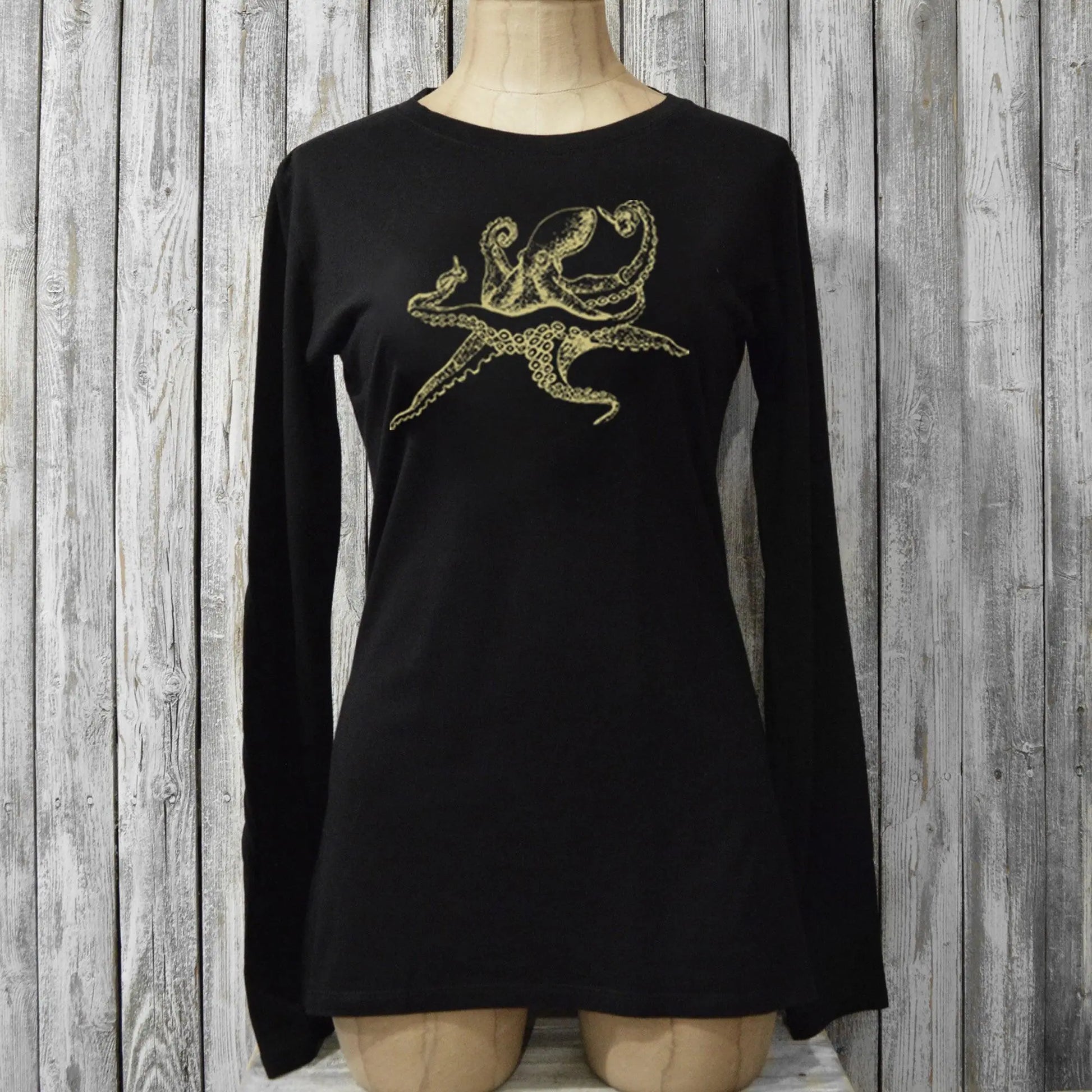 Fitted black Women's Octopus Long Sleeve T-Shirt on mannequin, made of bamboo and organic cotton with gold sea life graphic for eco-conscious style.