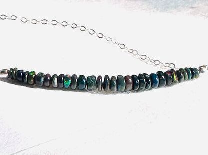 Close-up of Opal Bar Necklace showing vibrant multicolor opal beads strung on a sterling silver chain.