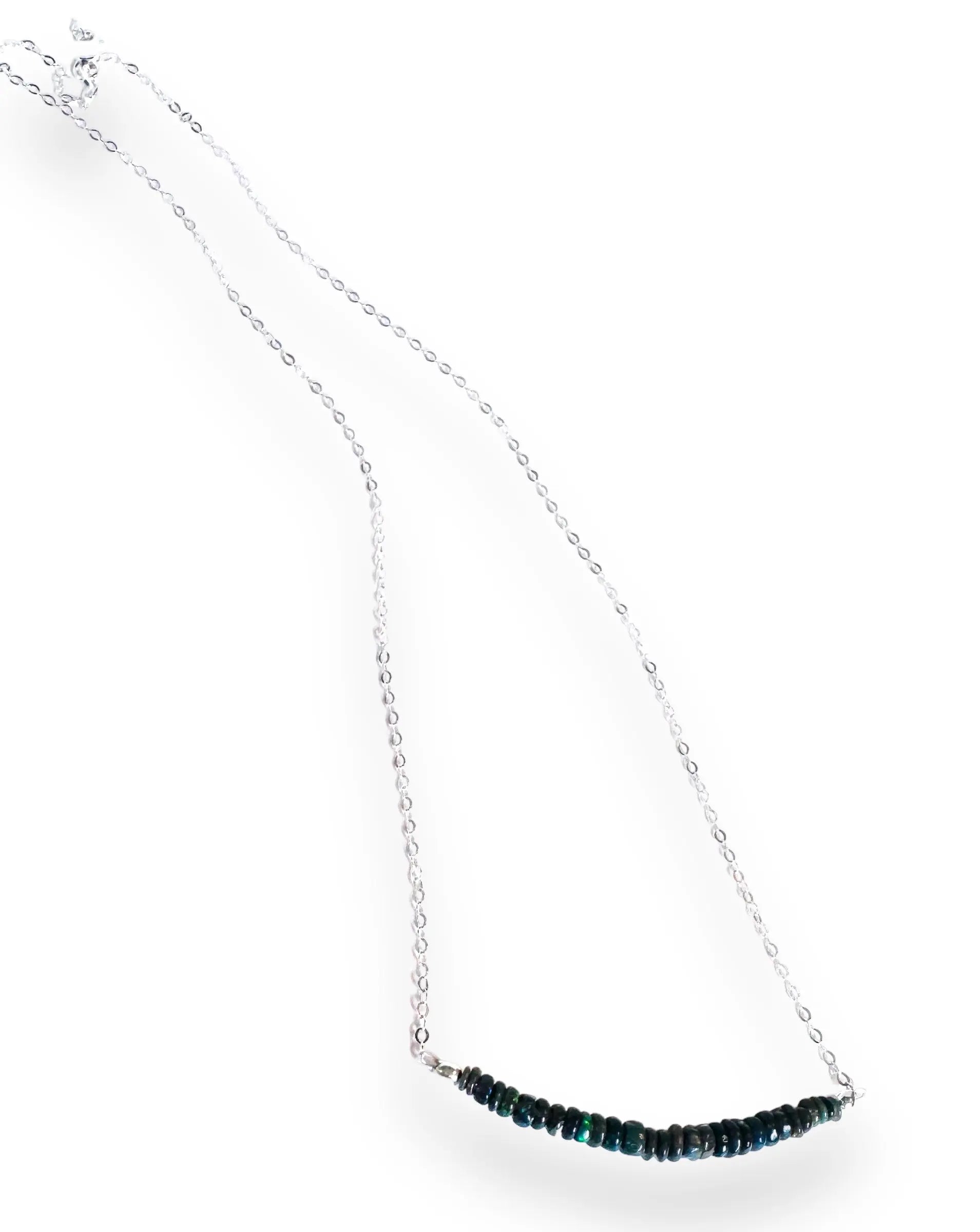Full view of Opal Bar Necklace featuring dark opal beads and a 17.5” sterling silver chain, laid out on white.