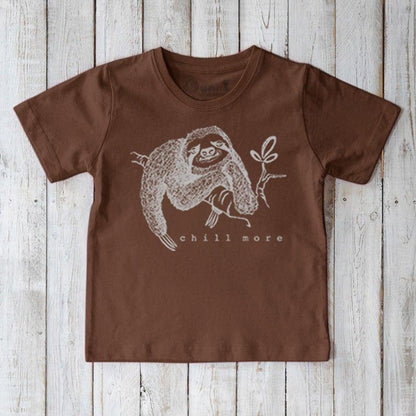 Brown Kids' Organic Cotton T-Shirt with white sloth illustration and 'chill more' text. Earth-toned eco-friendly tee for animal lovers.