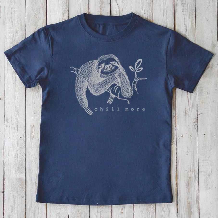 Navy Kids' Organic Cotton T-Shirt with white sloth design and 'chill more' slogan. Eco-friendly and stylish animal graphic tee for kids.