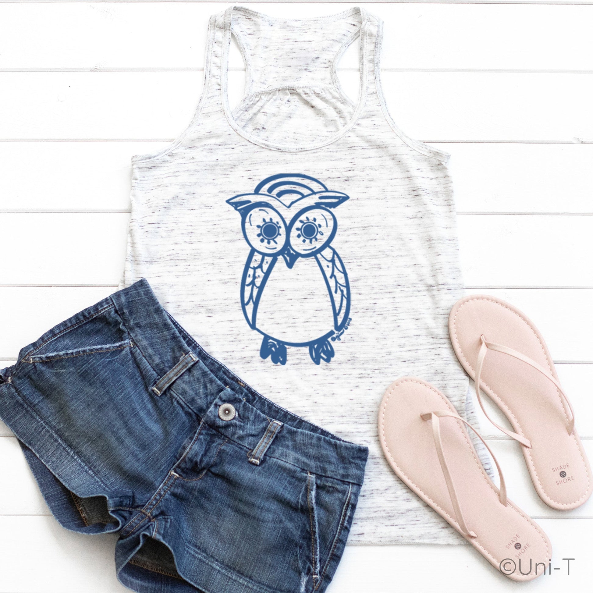 White Owl Flowy Tank Top for Women styled with denim shorts and sandals. Features blue owl graphic, perfect for summer and beachwear.